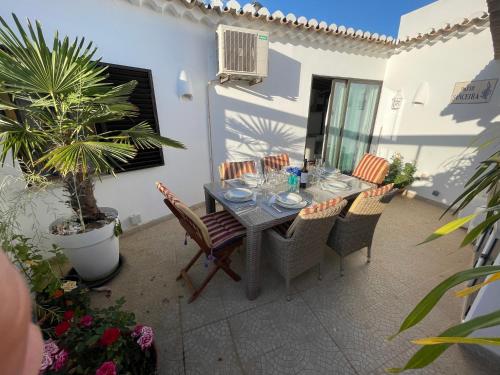 a dining table and chairs on a patio at Éden - Apartamento 1 in Lagos