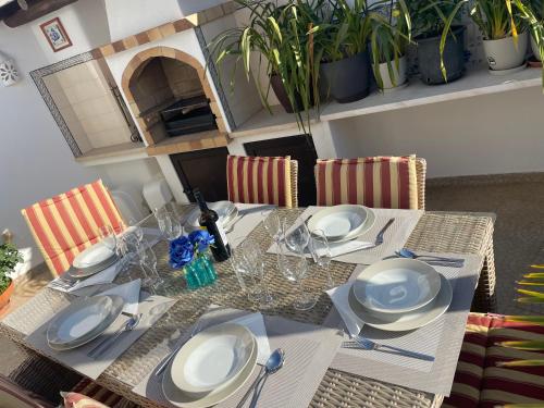 a dining room table with white plates and silverware at Éden - Apartamento 1 in Lagos
