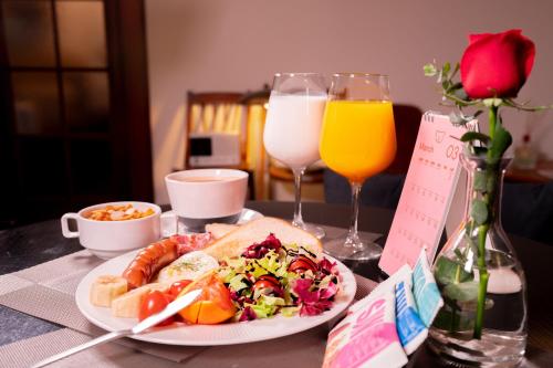 a table topped with a plate of food and drinks at Gangnam Boutique Hotel Sohsul in Seoul