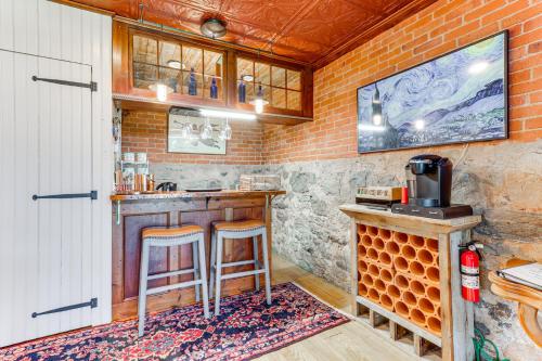 a kitchen with a counter and stools in a room at Downtown Essex Apartment - Steps to River! in Essex