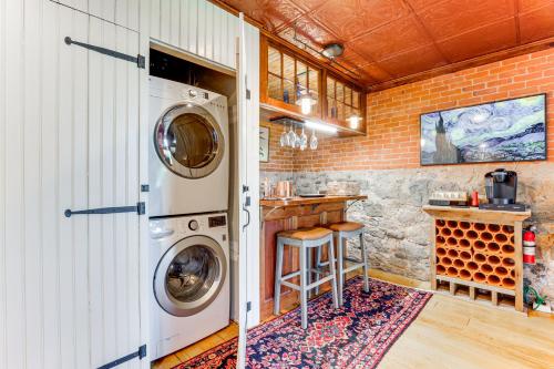 a laundry room with a washer and dryer at Downtown Essex Apartment - Steps to River! in Essex