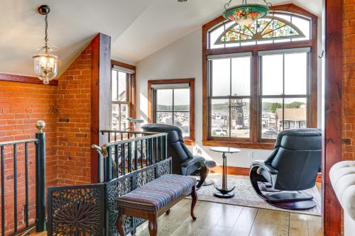 a living room with chairs and a window at Downtown Essex Apartment - Steps to River! in Essex