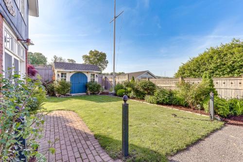 a yard with a fence and a blue door at Downtown Essex Apartment - Steps to River! in Essex