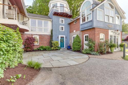 a brick house with a blue door at Downtown Essex Apartment - Steps to River! in Essex