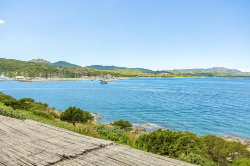 a view of a river with a bridge in the background at Sea View Apartment in Porto Rotondo