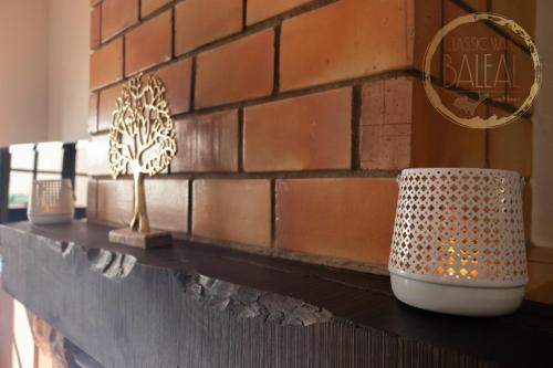 a counter with three vases on a brick wall at Baleal Classic Waves Guest House in Baleal