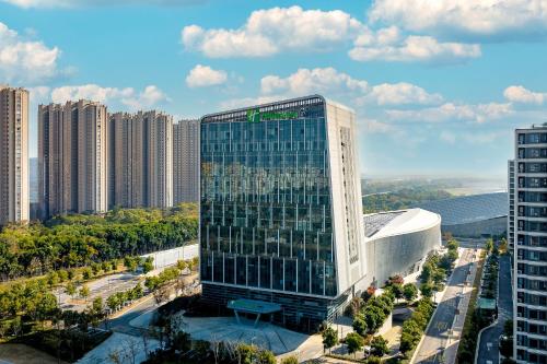 a tall building in a city with tall buildings at Holiday Inn Express Suzhou Bay by IHG in Suzhou