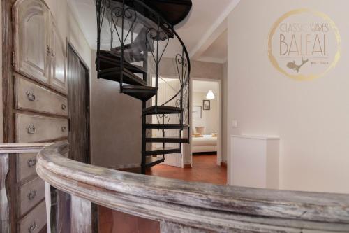a spiral staircase in a room with a living room at Baleal Classic Waves Guest House in Baleal