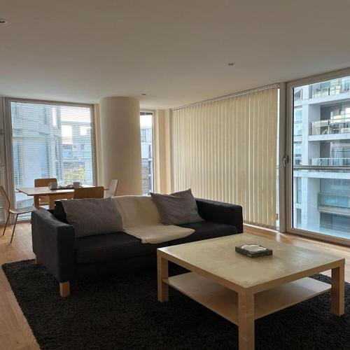 a living room with a couch and a coffee table at Canary Wharf - Luxury Apartments in London