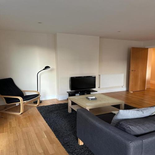 a living room with a couch and a coffee table at Canary Wharf - Luxury Apartments in London
