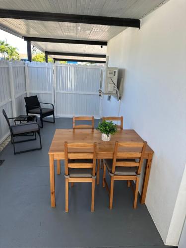 a wooden table and chairs on a patio at Adrien Guest Studio in Miami Gardens