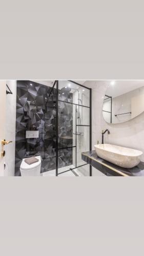 a bathroom with a tub and a toilet and a sink at Victory VIP apartments in Kallithea Halkidikis