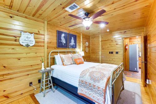 a bedroom with a bed and a ceiling fan at Riverfront Cabin with Outdoor Oasis in Seminary! in Collins