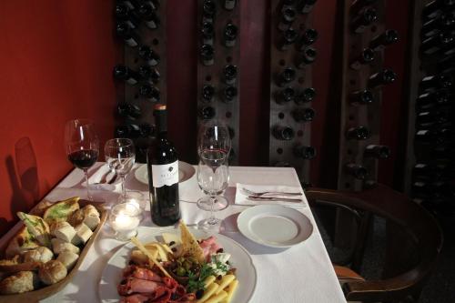 a table with a plate of food and wine glasses at Patios de Cafayate - Wine Hotel & Restaurant in Cafayate