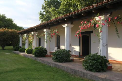 a house with flowers on the side of it at Patios de Cafayate - Wine Hotel & Restaurant in Cafayate