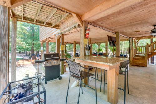 a kitchen with a table and chairs and a stove at Riverfront Cabin with Outdoor Oasis in Seminary! in Collins