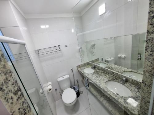 bagno con 2 lavandini, servizi igienici e specchio di Spazzio diRoma RM Hospedagem com Acesso Acqua Park/Splash a Caldas Novas