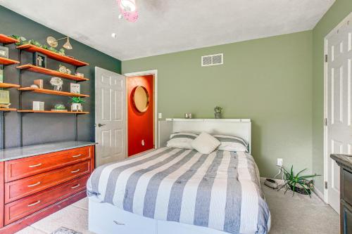 a bedroom with a bed and a red door at Menasha Home with Patio - Walking Distance to Lake! in Menasha