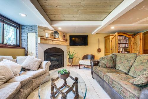 a living room with a couch and a fireplace at Menasha Home with Patio - Walking Distance to Lake! in Menasha