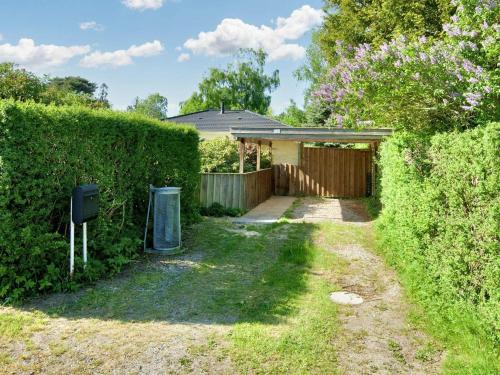 a yard with a fence and a house at 6 person holiday home in Gilleleje-By Traum in Gilleleje