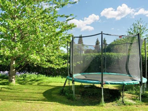 a trampoline with a net in a yard at 6 person holiday home in Gilleleje-By Traum in Gilleleje