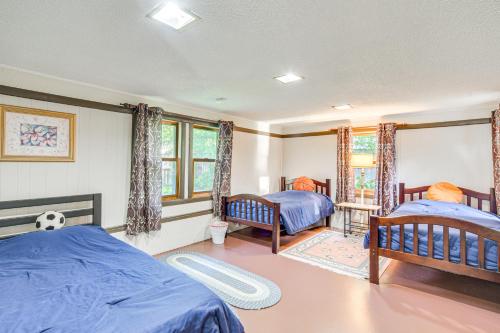 a bedroom with two beds and a soccer ball at Lakefront Family Retreat with Private Dock! in Rice Lake