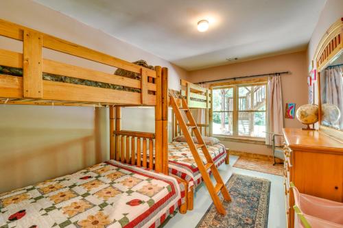 a bedroom with two bunk beds and a desk at Dog-Friendly Lavonia Home with Dock and Lake Access in Lavonia