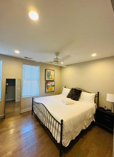 a bedroom with a large bed with white sheets at This property is unlisted in Cincinnati