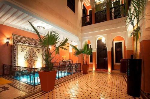 a lobby with potted plants in a building at Riad Moonlight & Spa in Marrakesh