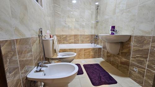 a bathroom with a toilet and a sink at Luxurious Apartment in Tabrbour شقة فخمة بطبربور in Amman