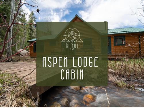 a sign for a resort lodge cabin next to a fire at Beyul Retreat in Meredith