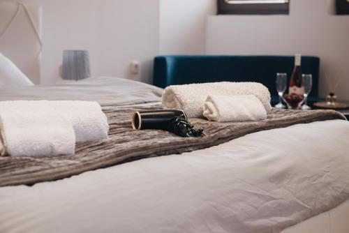 two beds with towels and wine glasses on them at St.Sofia Garden in Ohrid