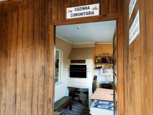 a doorway into a kitchen with a sign on the wall at Hotel Alvorada in Alegrete