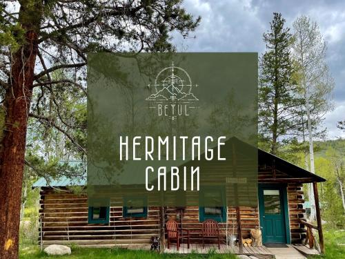a log cabin with a sign that reads heritage cabin at Beyul Retreat in Meredith