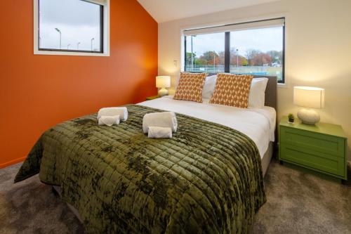a bedroom with a large bed with a large window at Serene Living 2 bed with Carpark in Christchurch