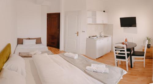 a living room with two beds and a table at St.Sofia Garden in Ohrid