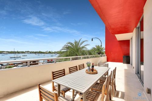 a table and chairs on a balcony with a view of the water at Beachfront Condo-ROOFTO POOL- 2 BEDROOMS 2 BR ! in Hollywood