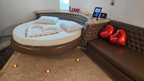 a bed in a room with two hearts on the floor at A2 suites - Hotel e Motel in Brasilia