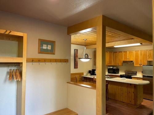 a kitchen with wooden cabinets and a counter top at Mount Shasta Resort in Mount Shasta