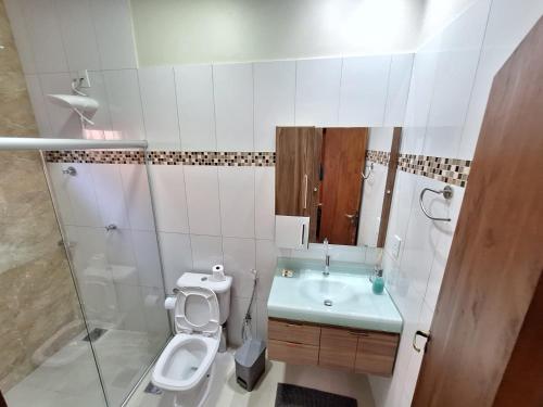 a bathroom with a toilet and a sink and a shower at Casa Acerola - Vila de São Jorge in Sao Jorge