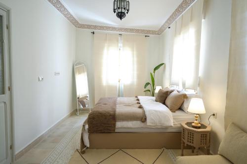 a bedroom with a large bed and a mirror at Dar Badr in Tangier