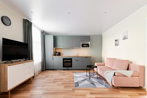 a living room with a couch and a television at Liidia Apartments in Haapsalu