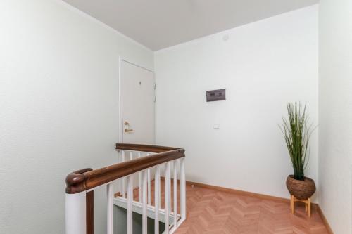 a staircase with a potted plant in a room at Liidia Apartments in Haapsalu