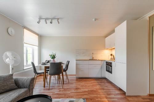 a kitchen and living room with a table and chairs at Liidia Apartments in Haapsalu