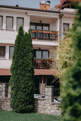 a large building with a balcony and a tree at St.Sofia Garden in Ohrid