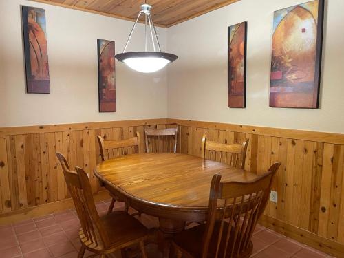 a dining room with a wooden table and chairs at Mount Shasta Resort in Mount Shasta