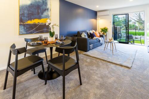 a living room with a table and chairs and a couch at Cozy 2 Bedroom Near City Biking and Trails in Christchurch