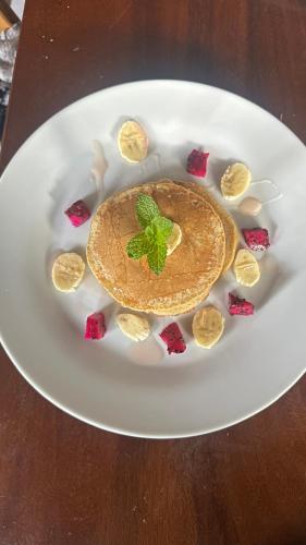 a white plate with a dessert on a table at Volcano Valley in Kintamani