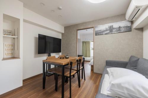 a living room with a table and a couch at self-check in-5mins walk from shinokubo station free wifi in Tokyo
