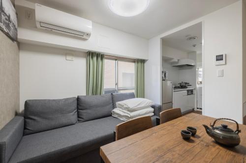 a living room with a couch and a table at self-check in-5mins walk from shinokubo station free wifi in Tokyo